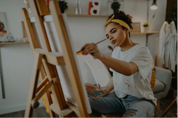 learner painting on a canvas on an easel