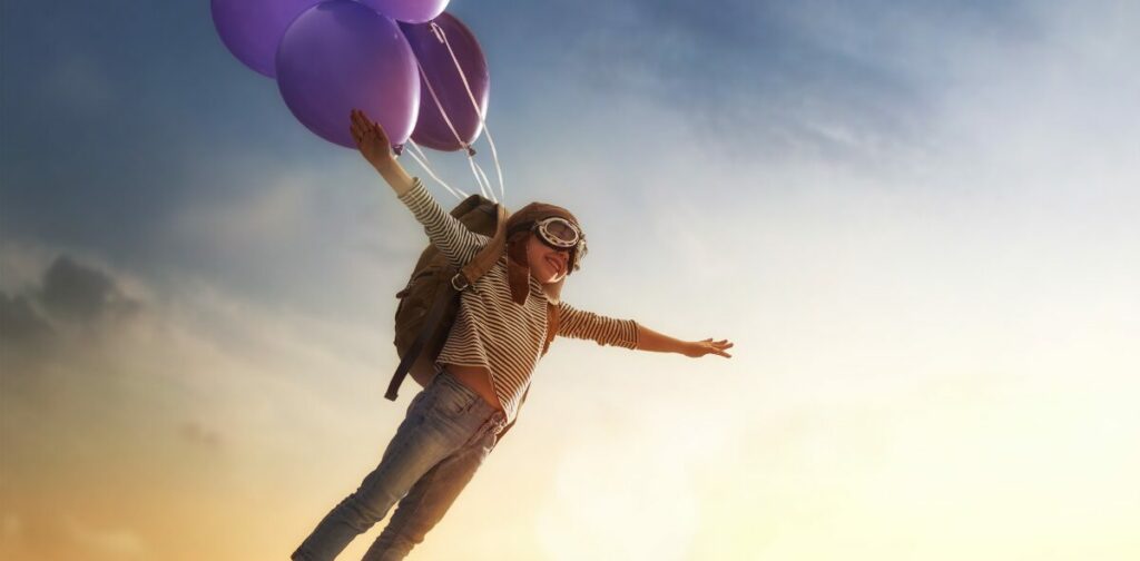 soaring young learner wearing a backpack and balloons