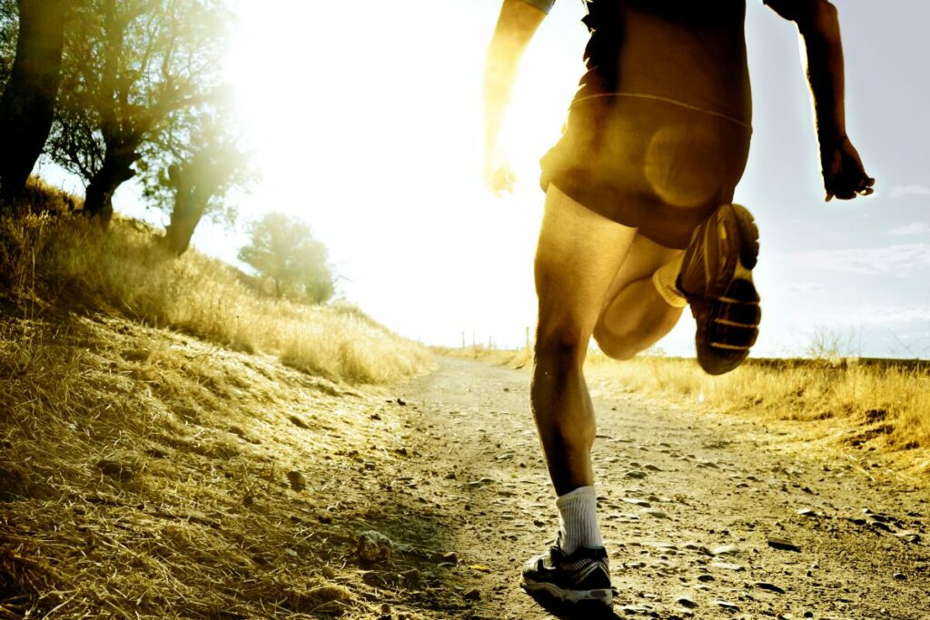 close up photo of a runner running on a trail outside