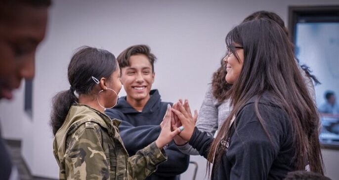 learners high-fiving in a circle