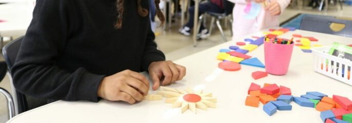 learner making a flower with wooden blocks