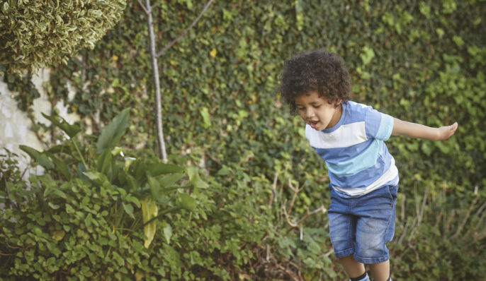 young learner playing in the garden