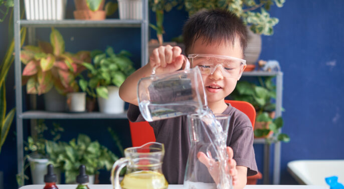 young learner wearing safety goggles in science lab