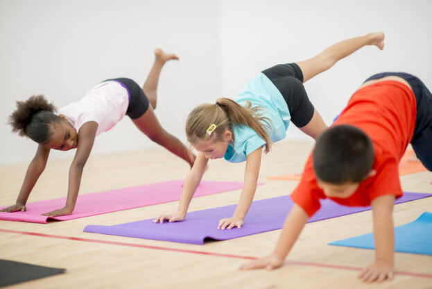 learners doing yoga on yoga mats