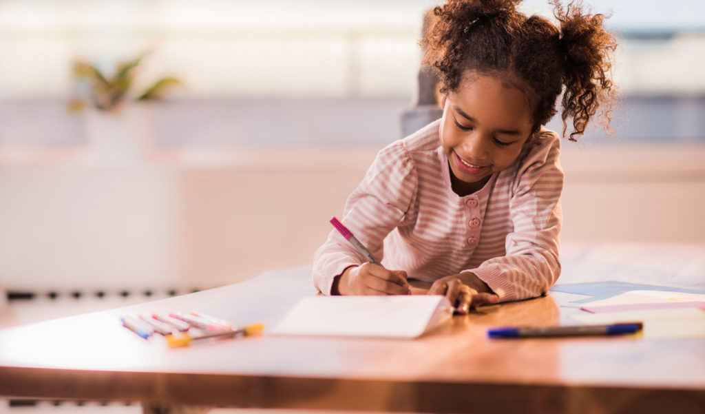 young learner drawing with markers