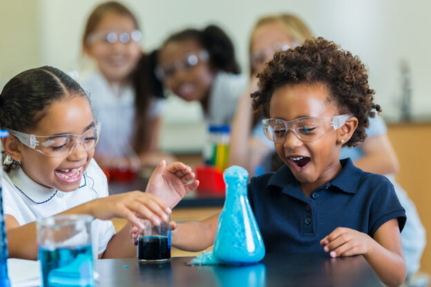 young learners wearing safety goggles in a science lab