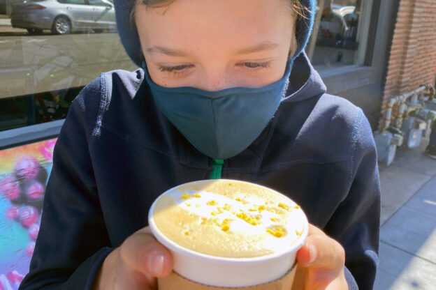 close up photo of a learner holding a hot cocoa