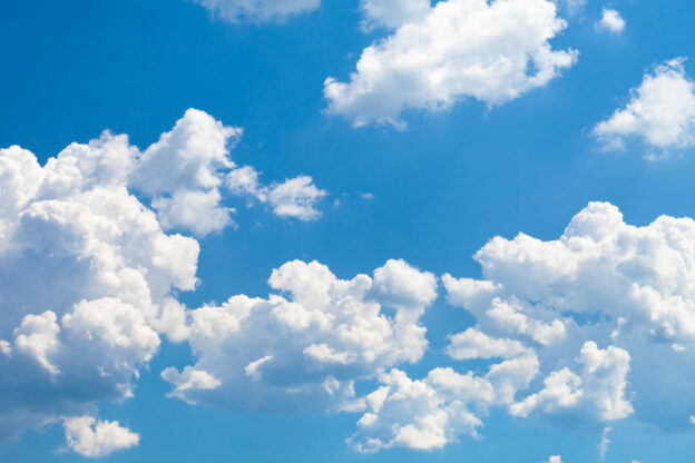 photo of a bright blue sky with fluffy clouds