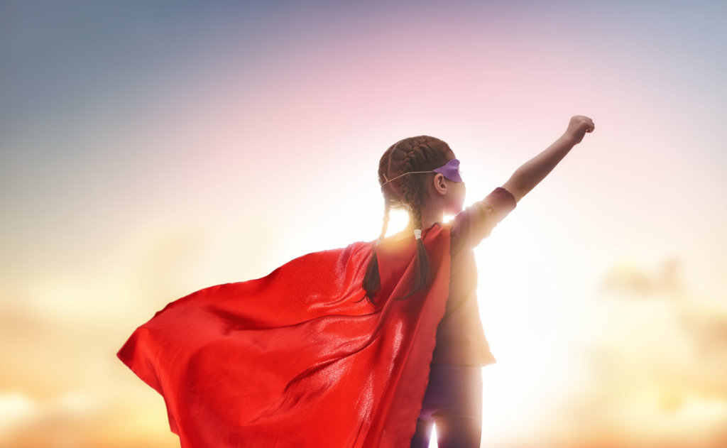 photo of a young learner wearing a cape