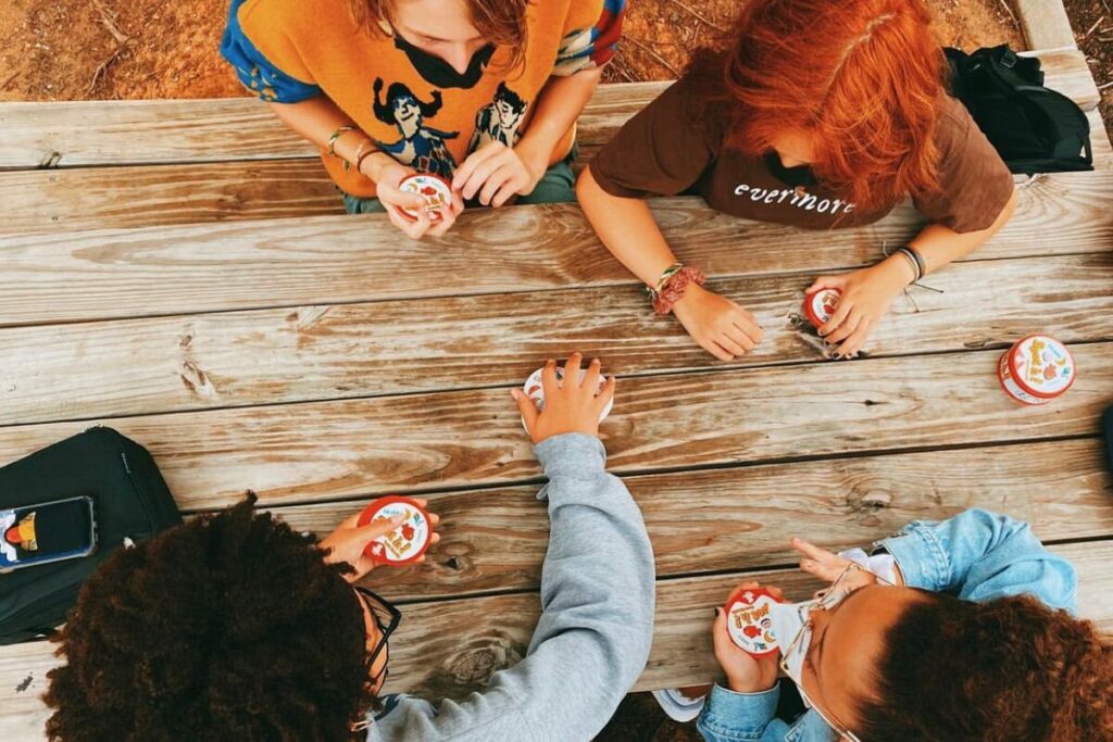 aerial photo of Charlotte Lab School learners sitting at a picnic table playing a game