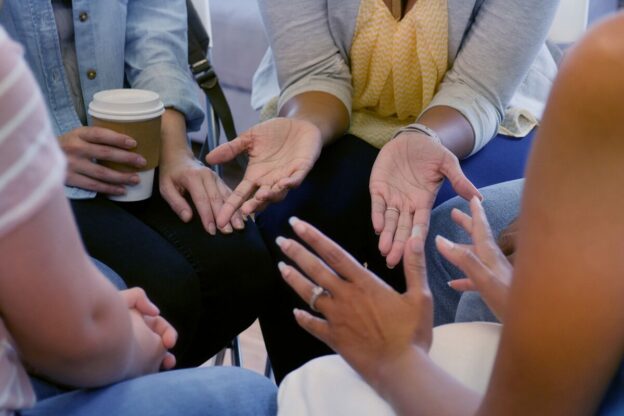 close up of hands in an intimate circle