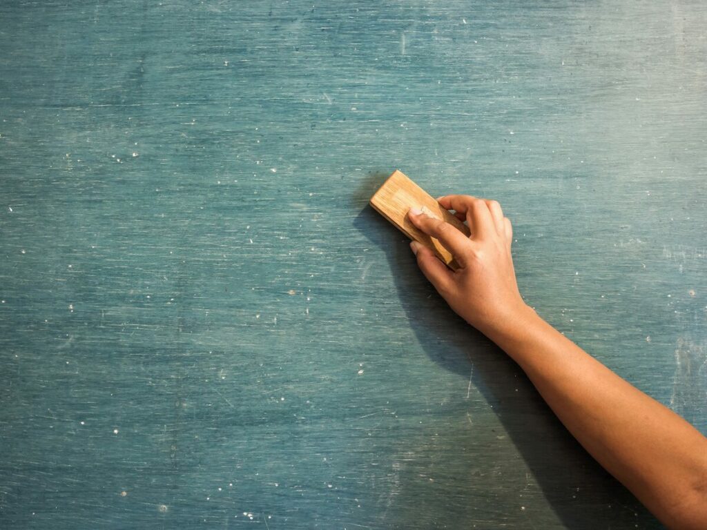 photo of a learner's arm holding an eraser on a chalkboard