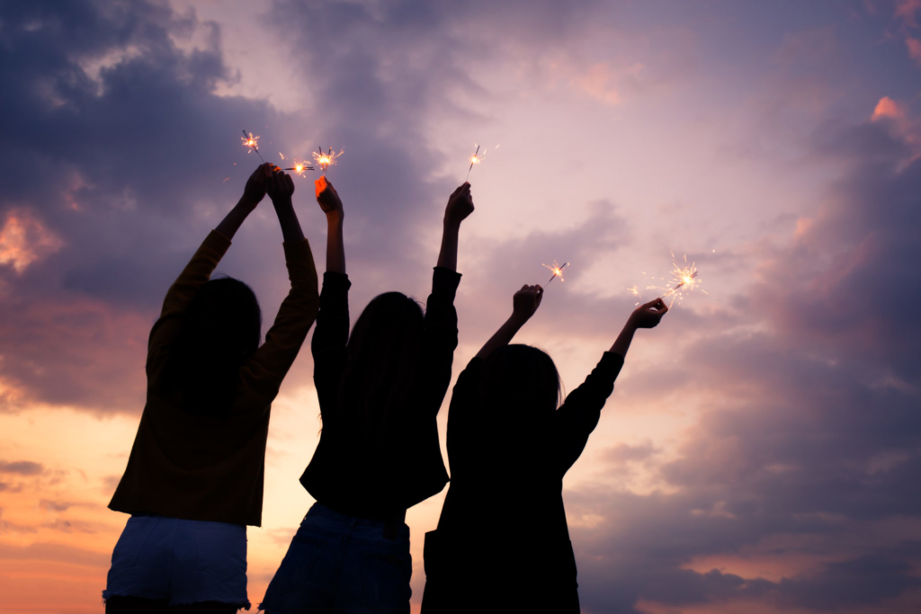 silhouettes of learners holding sparklers