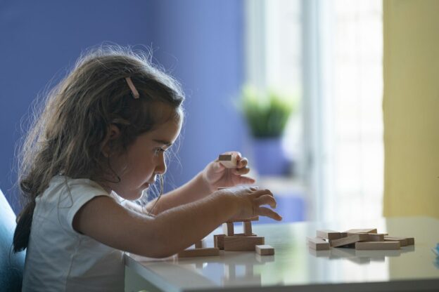 young learner building with blocks