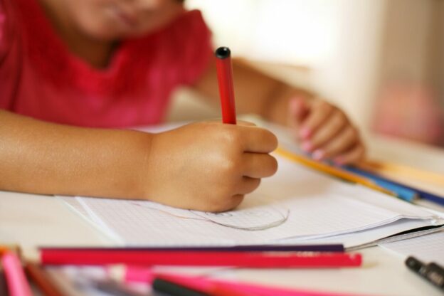 young learner drawing on paper