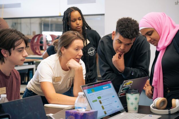 learners around a computer at The Past Foundation