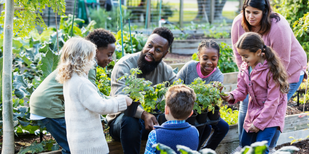 educators and learners together in a garden