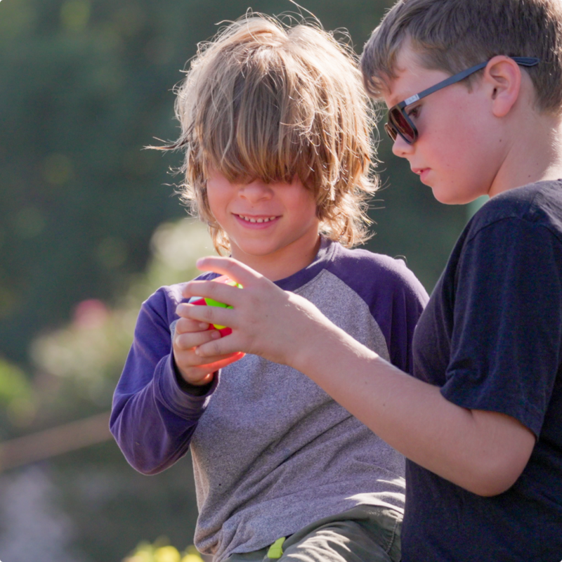 Rock Tree Sky learners holding a ball outside