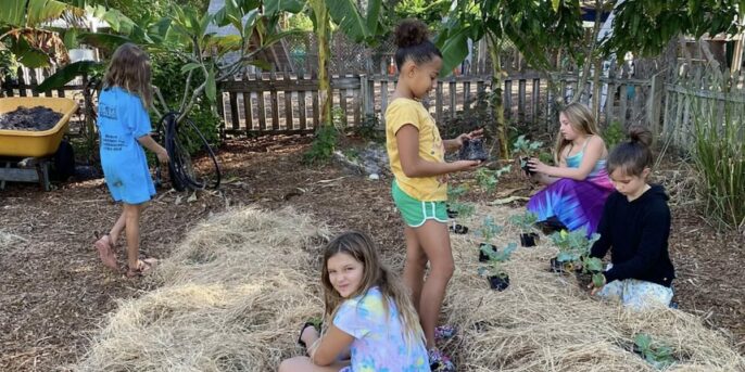 Five young learners exploring the garden at Verdi EcoSchool