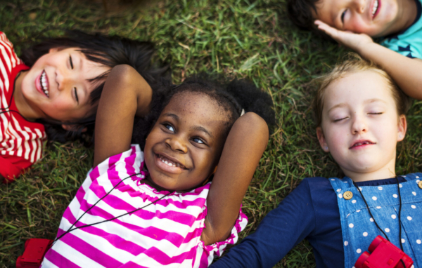 aerial photo of young learners lying on the grass