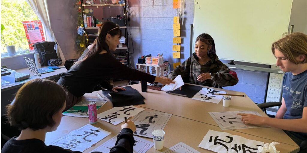 Young people in a studio learning calligraphy 