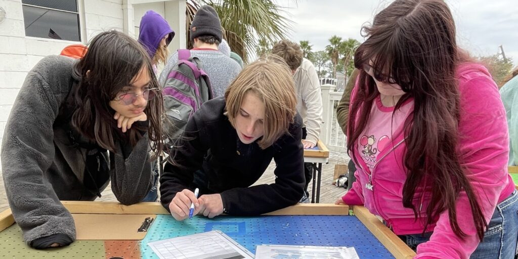 Learners outside brainstorming a project together